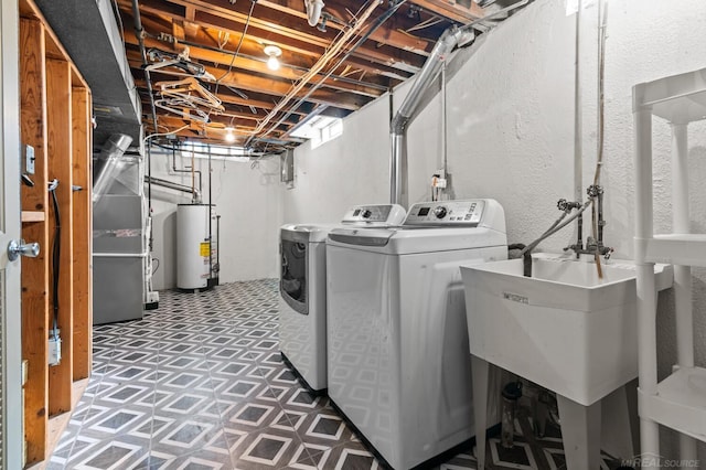 laundry room featuring independent washer and dryer, laundry area, and water heater