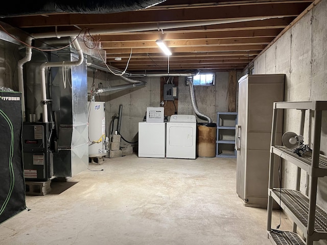 below grade area featuring water heater, electric panel, and washing machine and clothes dryer