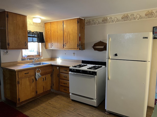 kitchen featuring white appliances, brown cabinetry, dark wood finished floors, a sink, and light countertops