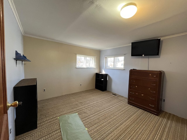 unfurnished bedroom featuring visible vents, ornamental molding, and carpet floors