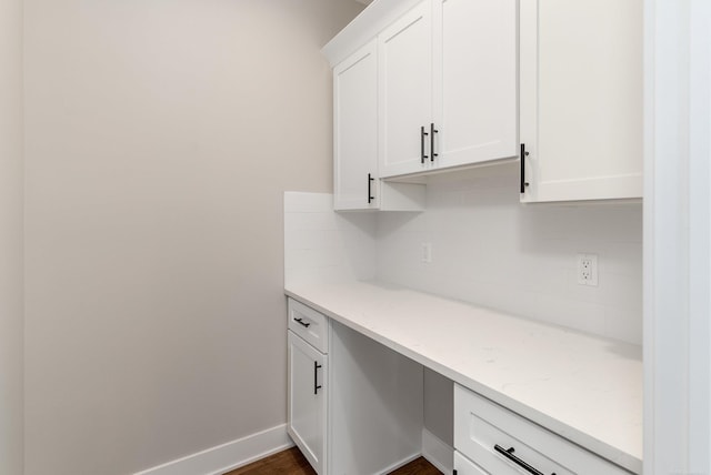 office space with dark wood finished floors and baseboards