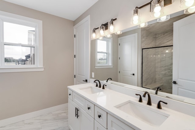 full bathroom featuring a sink, baseboards, marble finish floor, and a tile shower