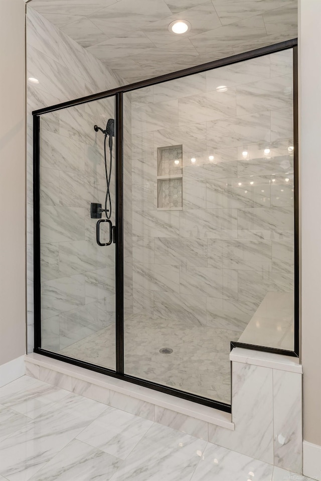 full bath with marble finish floor and a stall shower