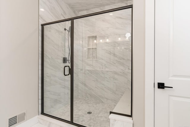 bathroom featuring visible vents, marble finish floor, and a stall shower