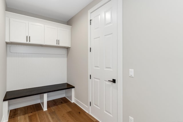 mudroom featuring baseboards and wood finished floors