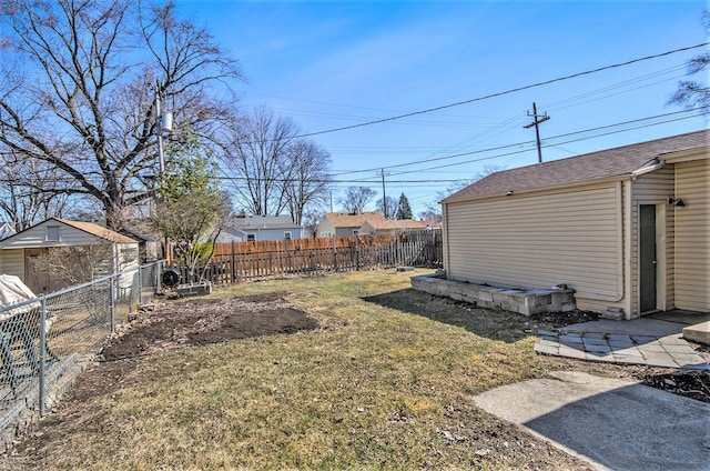 view of yard with an outdoor structure and a fenced backyard