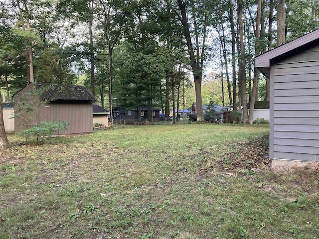 view of yard with an outbuilding and a shed