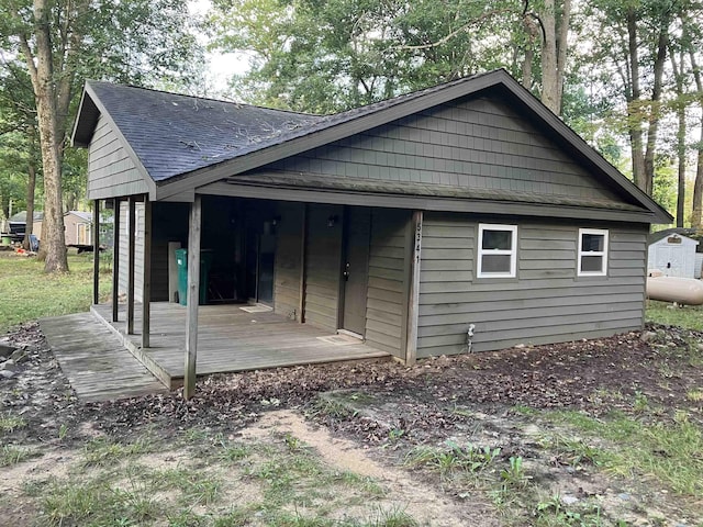 view of home's exterior featuring roof with shingles