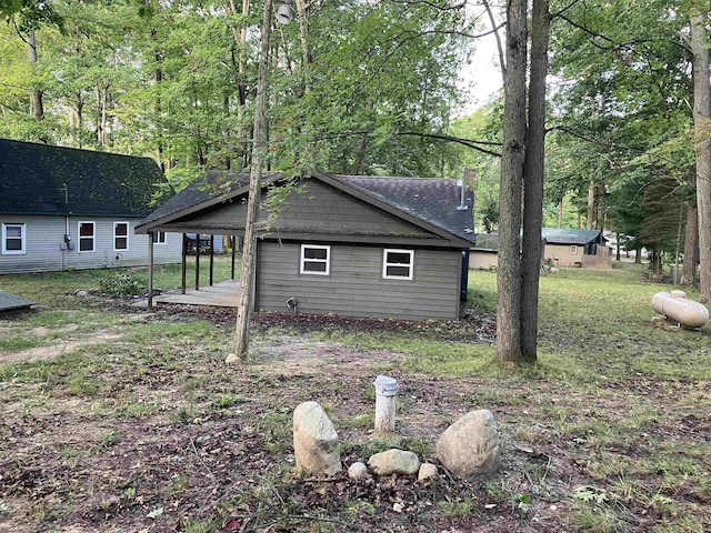 view of home's exterior with a lawn and a chimney