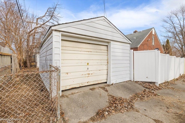 detached garage featuring fence