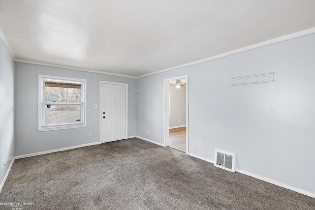 spare room featuring visible vents, dark carpet, baseboards, and ornamental molding