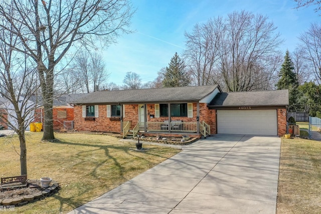 ranch-style house featuring fence, an attached garage, covered porch, a front lawn, and concrete driveway