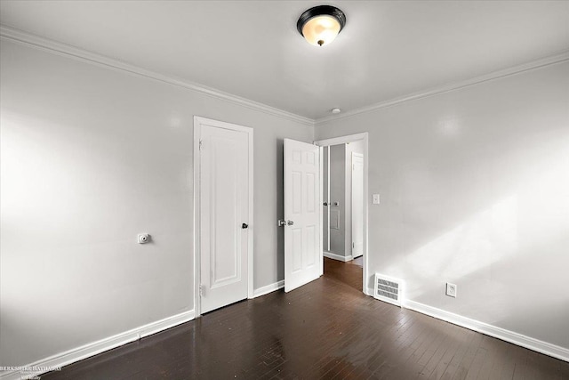 unfurnished bedroom with baseboards, dark wood-style floors, and crown molding