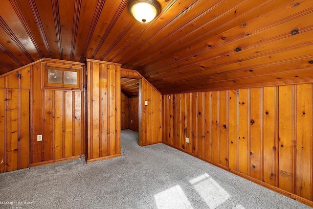 additional living space featuring vaulted ceiling, wooden walls, carpet flooring, and wood ceiling