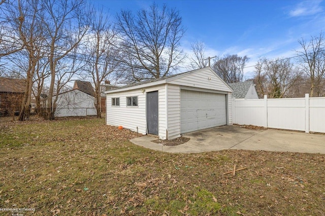 detached garage featuring fence