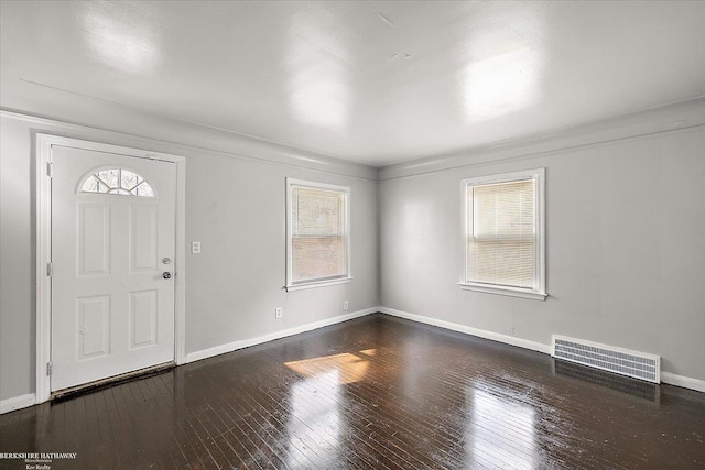 entryway featuring hardwood / wood-style floors, baseboards, and visible vents