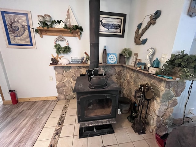 interior details featuring a wood stove, baseboards, and a fire extinguisher