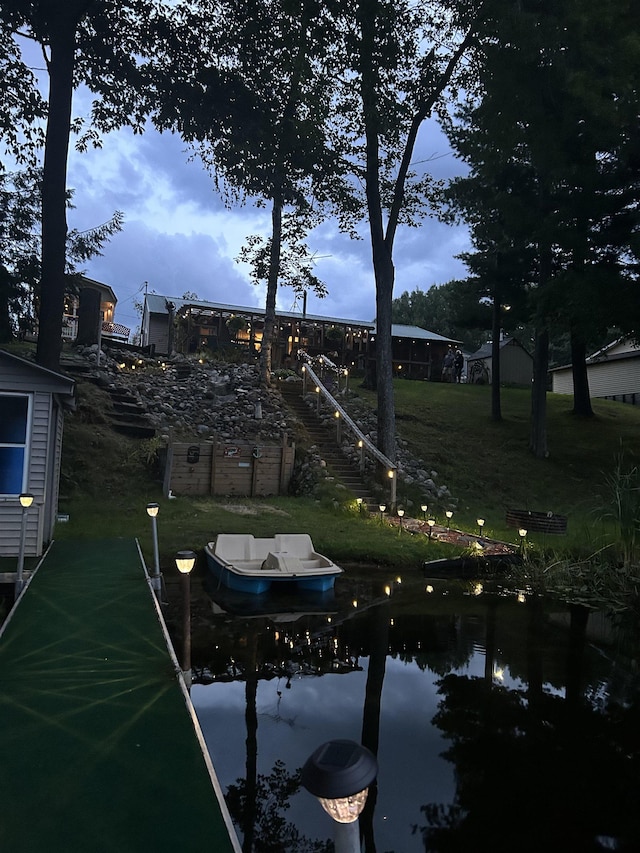 dock area with stairs and a yard