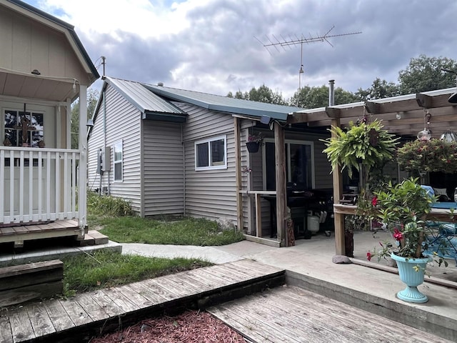 back of property featuring metal roof