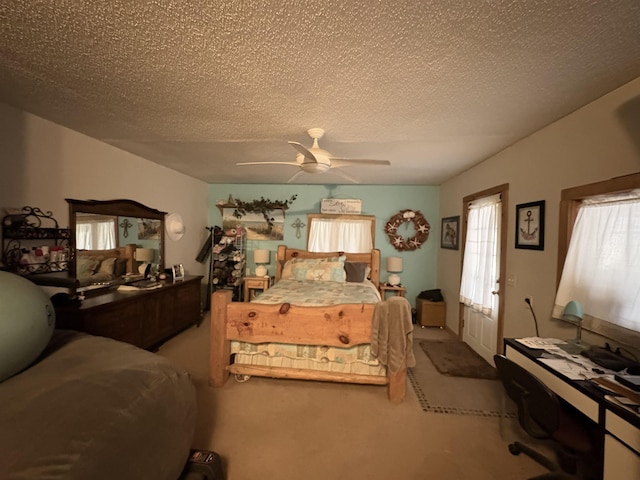 carpeted bedroom with a textured ceiling and ceiling fan