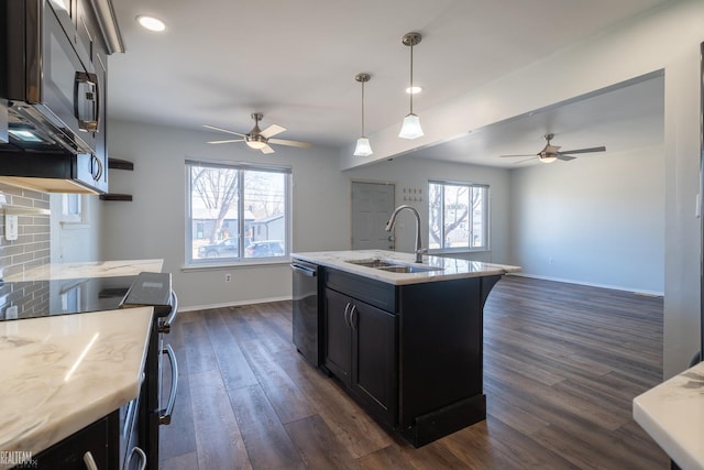 kitchen featuring ceiling fan, open floor plan, stainless steel appliances, and a sink