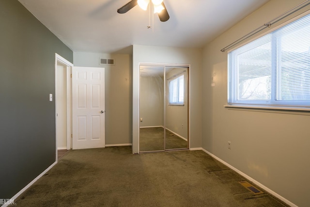 unfurnished bedroom featuring a closet, visible vents, baseboards, and carpet floors