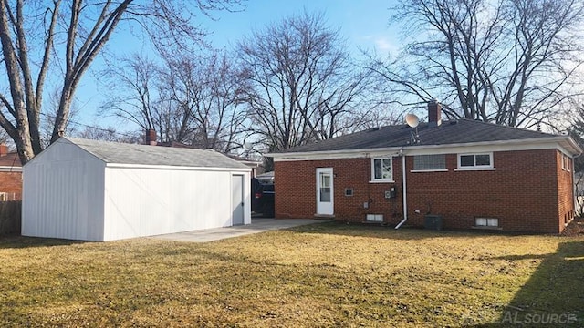 back of property with brick siding, a lawn, a chimney, an outbuilding, and a storage unit