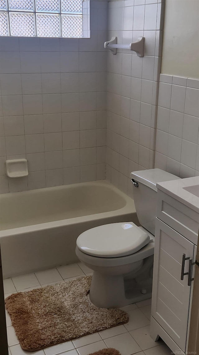 full bathroom with tile patterned flooring, vanity, toilet, and tile walls