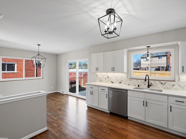 kitchen featuring a sink, backsplash, a chandelier, dark wood finished floors, and stainless steel dishwasher