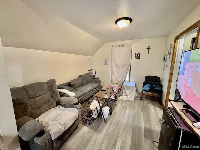 living area with light wood-type flooring and vaulted ceiling