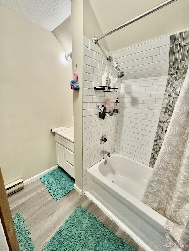 full bath with a baseboard heating unit, vanity, wood finished floors, and shower / tub combo with curtain