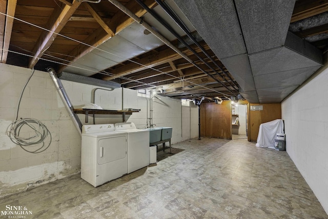 unfinished basement featuring tile patterned floors and washer and clothes dryer