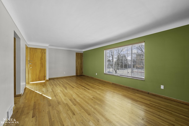 interior space with visible vents, baseboards, and wood finished floors