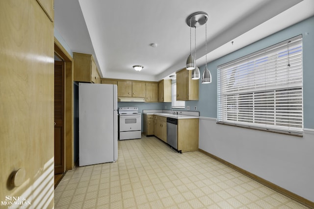 kitchen with baseboards, light floors, light countertops, white appliances, and a sink