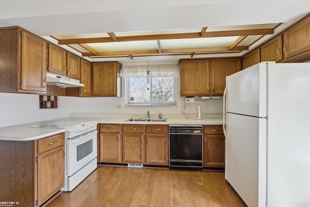 kitchen with white appliances, light wood-style flooring, a sink, under cabinet range hood, and brown cabinets