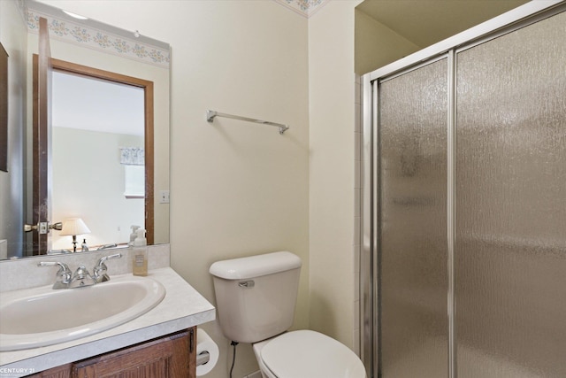 full bathroom featuring vanity, a shower stall, and toilet