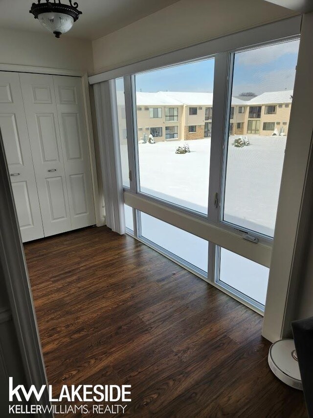 unfurnished bedroom featuring a closet and dark wood-type flooring