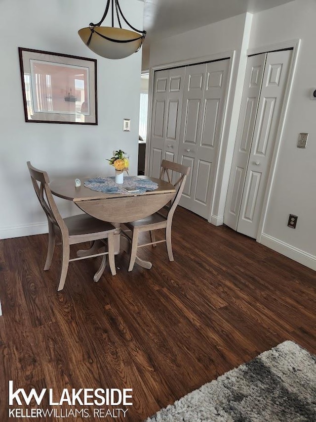 dining room with dark wood-style floors and baseboards