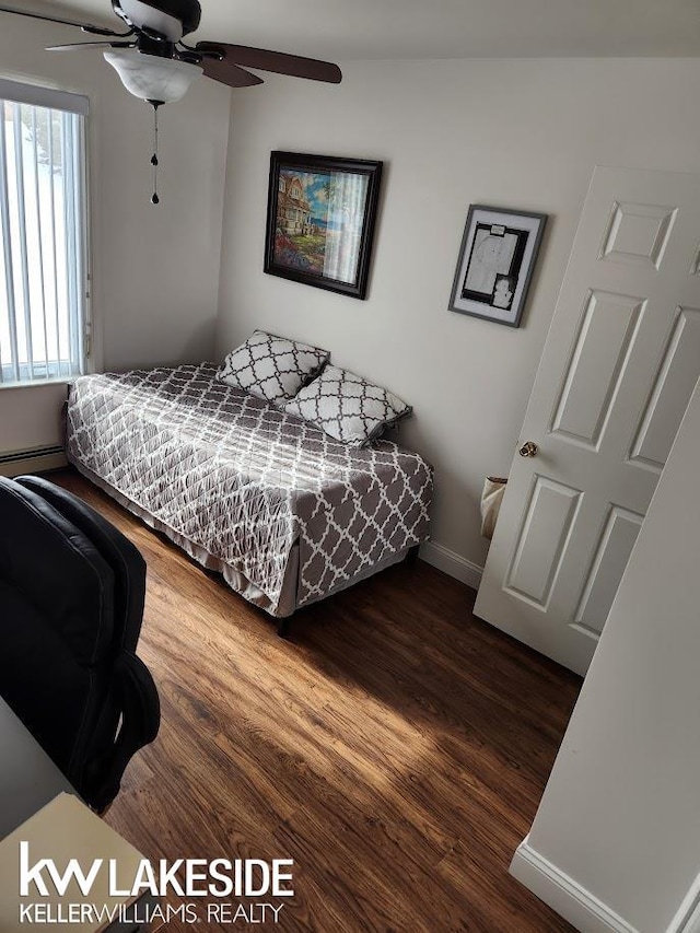 bedroom featuring a ceiling fan, wood finished floors, and baseboards