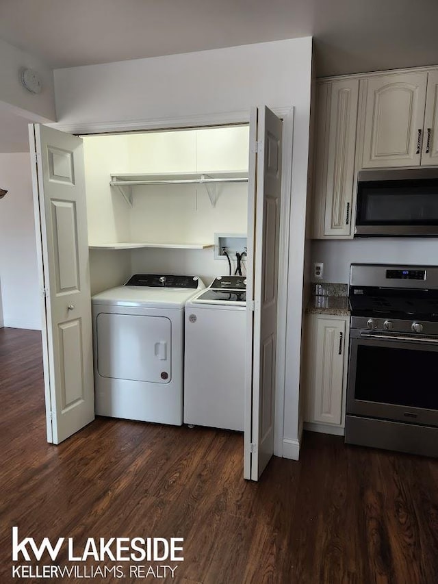 washroom with laundry area, independent washer and dryer, and dark wood-type flooring