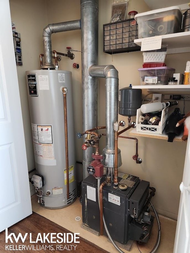 utility room featuring water heater