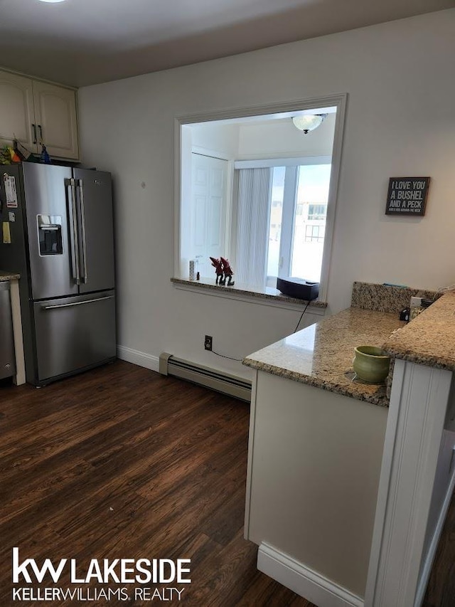 kitchen featuring light stone counters, white cabinetry, appliances with stainless steel finishes, a baseboard radiator, and dark wood-style flooring