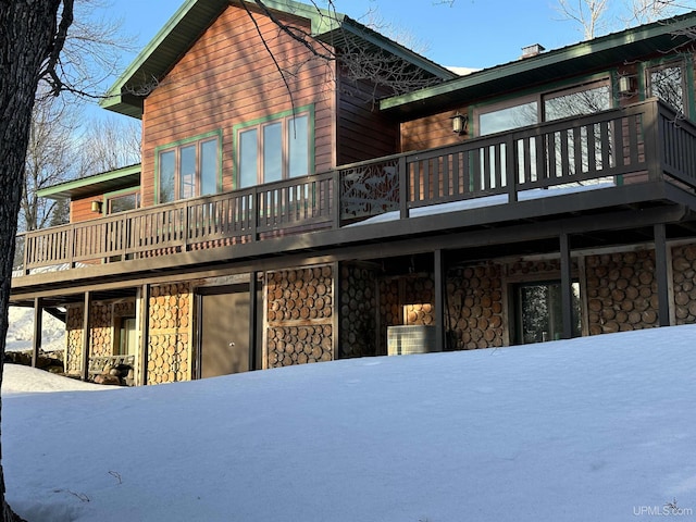 rear view of house with stone siding