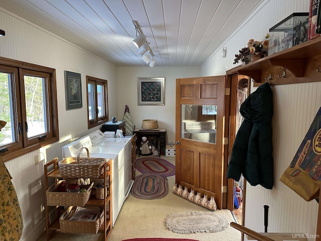 washroom with carpet floors, laundry area, separate washer and dryer, rail lighting, and wood ceiling