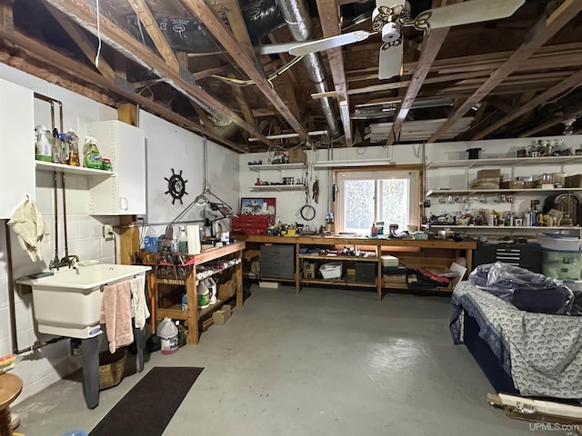 miscellaneous room with a workshop area and finished concrete floors