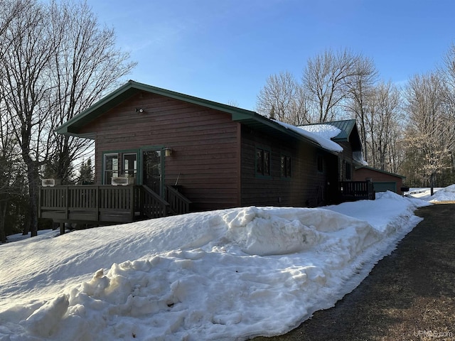 view of snow covered exterior featuring a deck