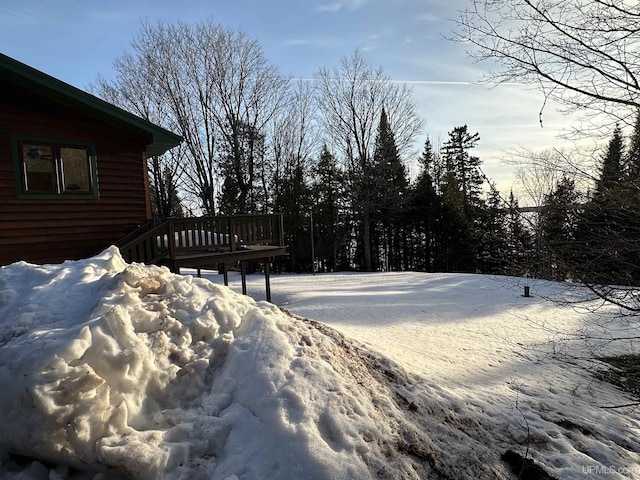 snowy yard featuring a deck