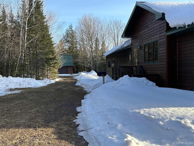 snow covered property with a garage