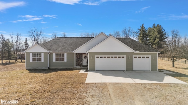 single story home with a front yard, an attached garage, roof with shingles, and driveway