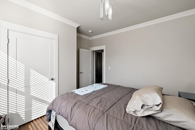 bedroom featuring wood finished floors and ornamental molding